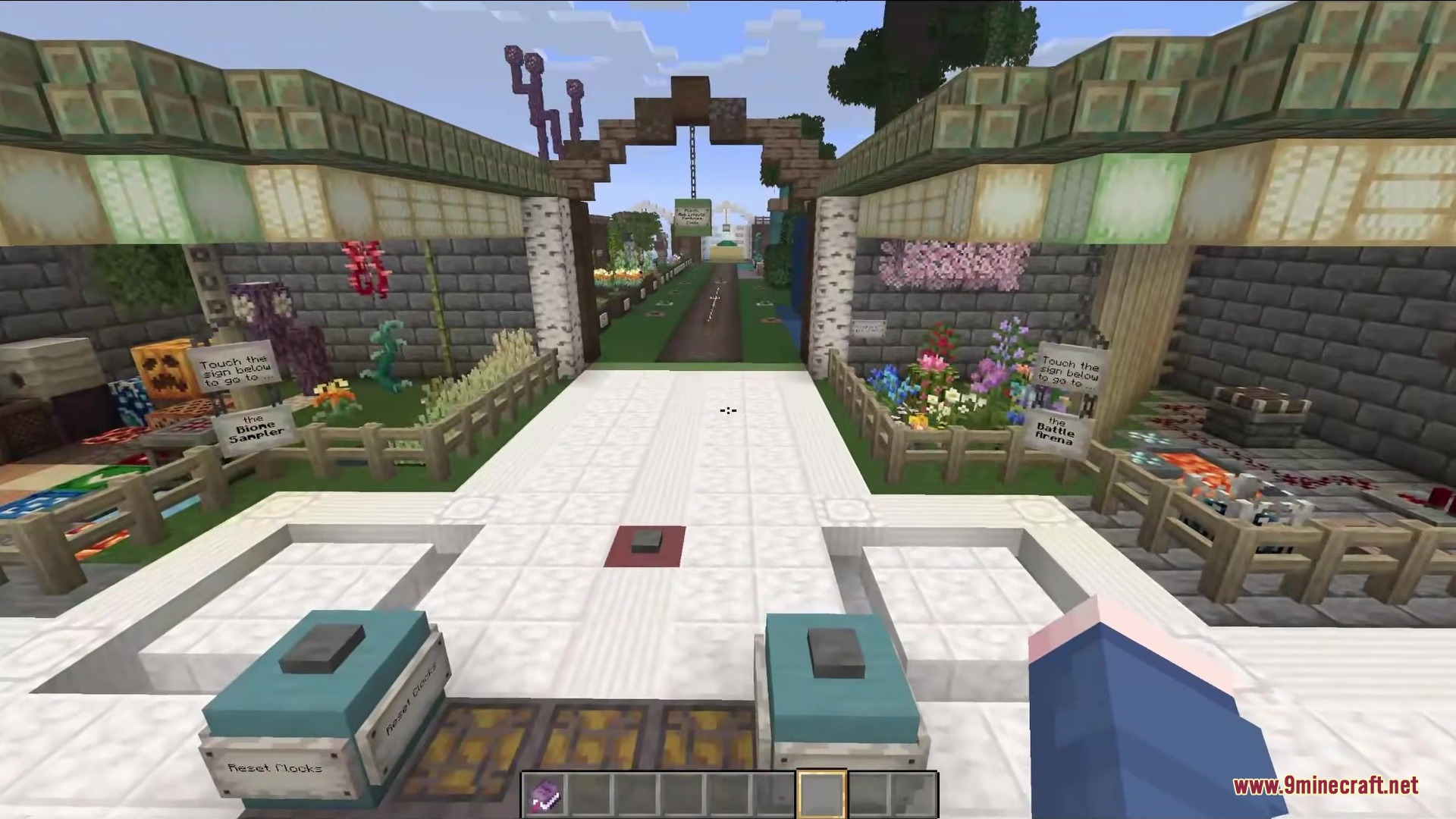 A stone courtyard with pathways leading to flower gardens and themed areas