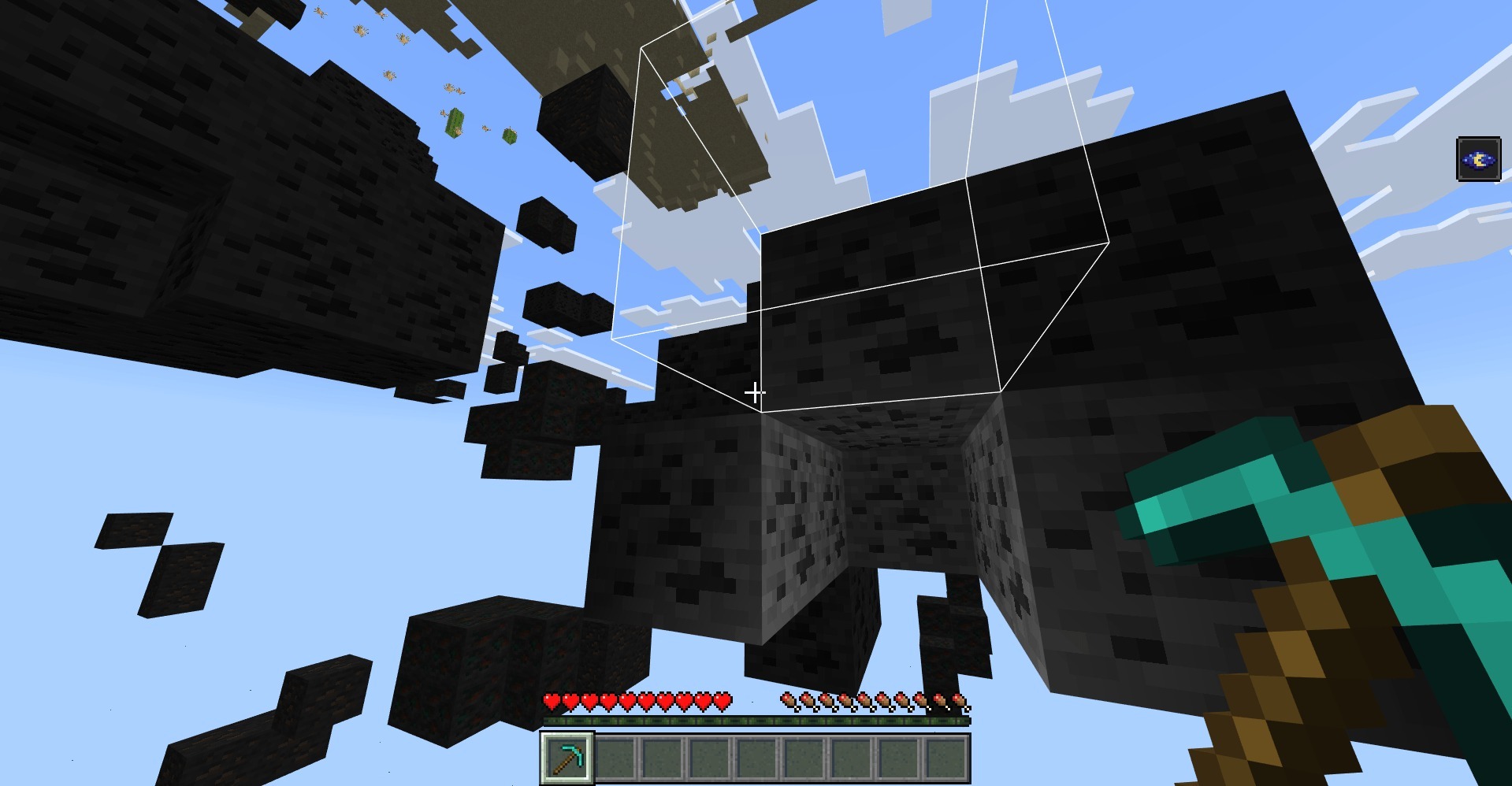 Minecraft player holding a diamond pickaxe while looking at highlighted coal ore blocks