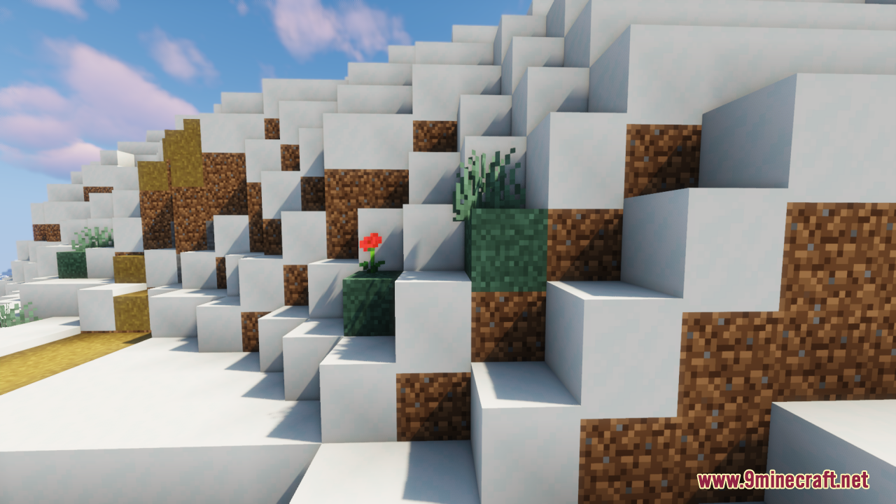 Snowy hillside featuring connected grass textures and a single red poppy flower