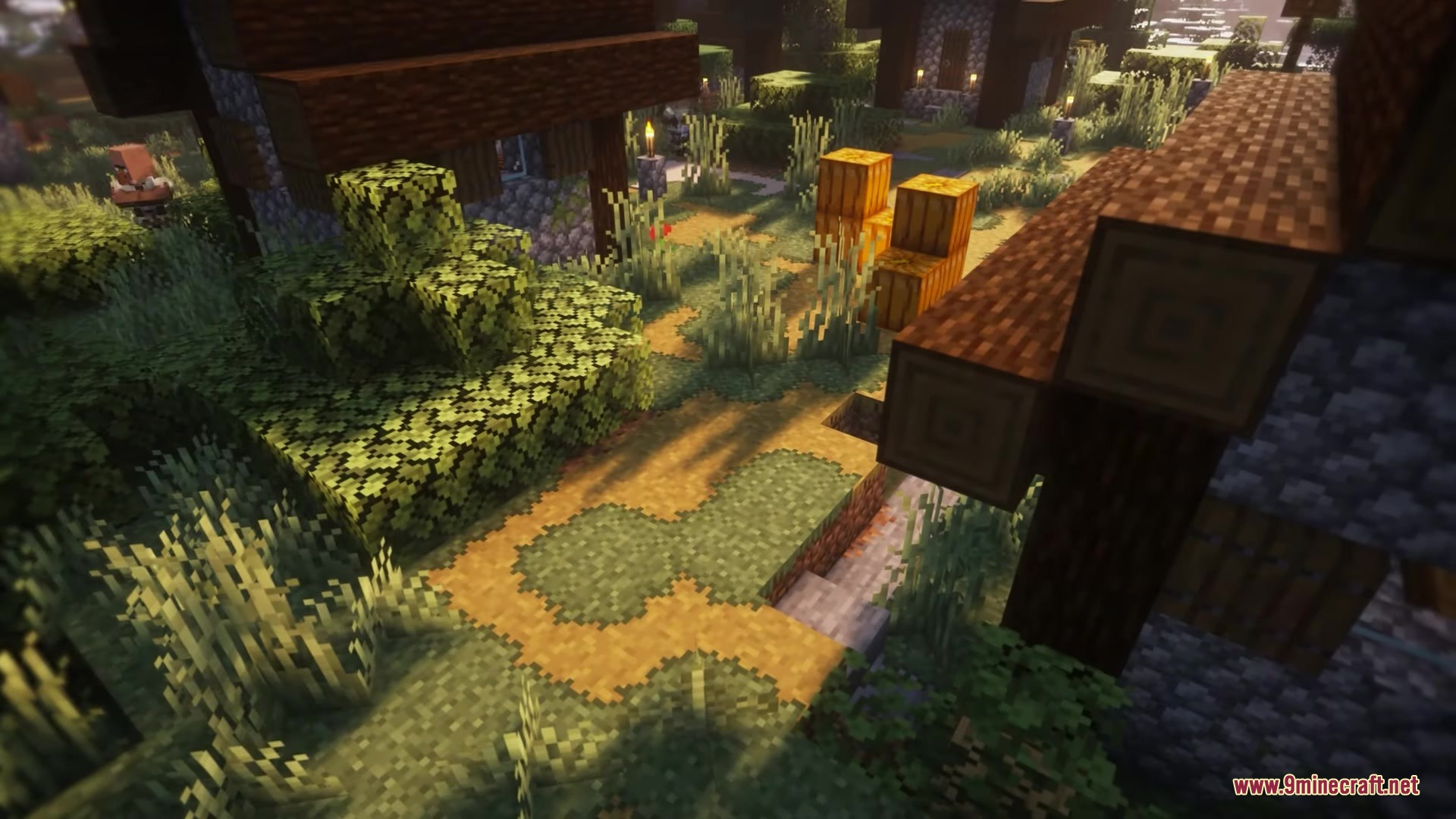 Better Vanilla Building Overlays Resource Pack Screenshot 8 Minecraft village path featuring natural terrain edges and stacked orange pumpkin blocks