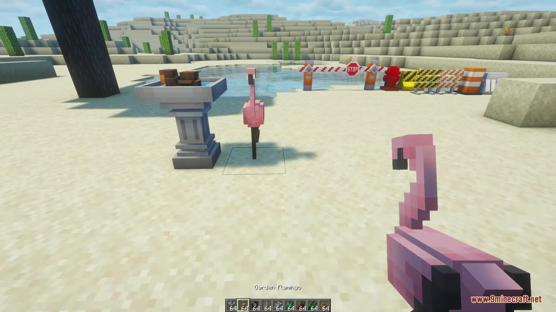 Beyond Outdoors Mod Screenshot 3 A player holds a pink garden flamingo near a birdbath in Minecraft