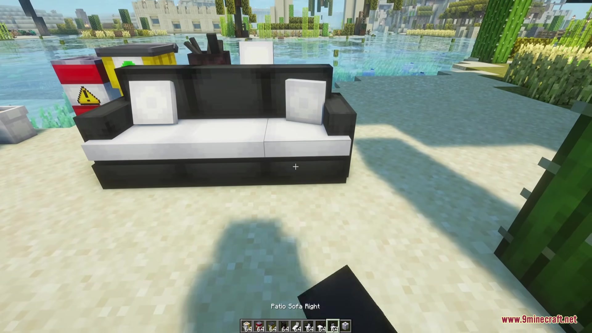 Beyond Outdoors Mod Screenshot 8 A modern black and white patio sofa placed on a sandy beach area
