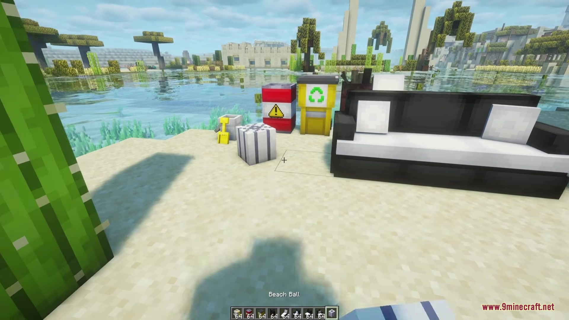 Beyond Outdoors Mod Screenshot 9 A black sofa and colorful recycling bins placed on a sandy beach