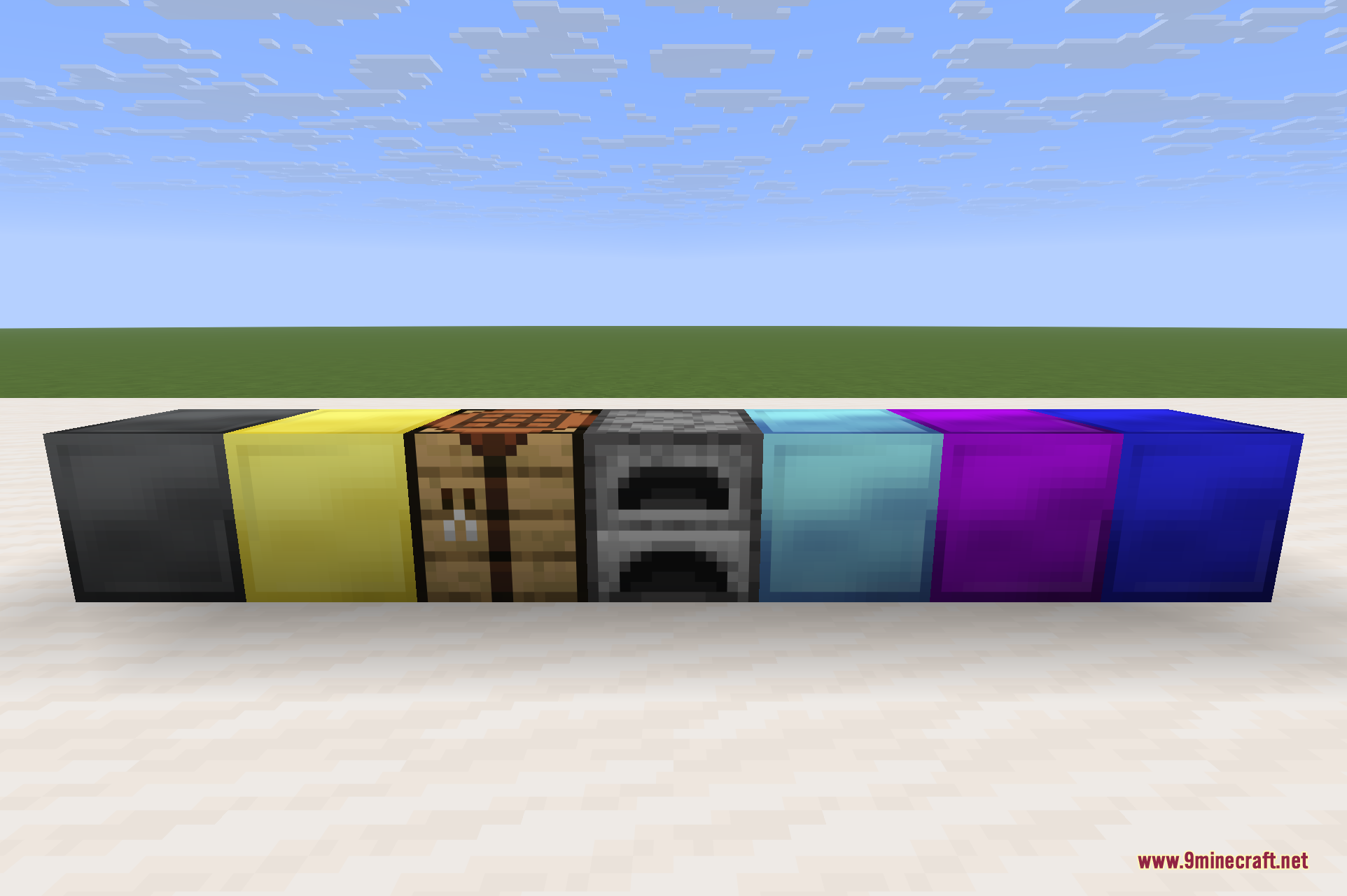 A row of Big Reactors component blocks laid out on the ground, including reactor casing, ports, reactor glass, and other coloured multiblock parts.