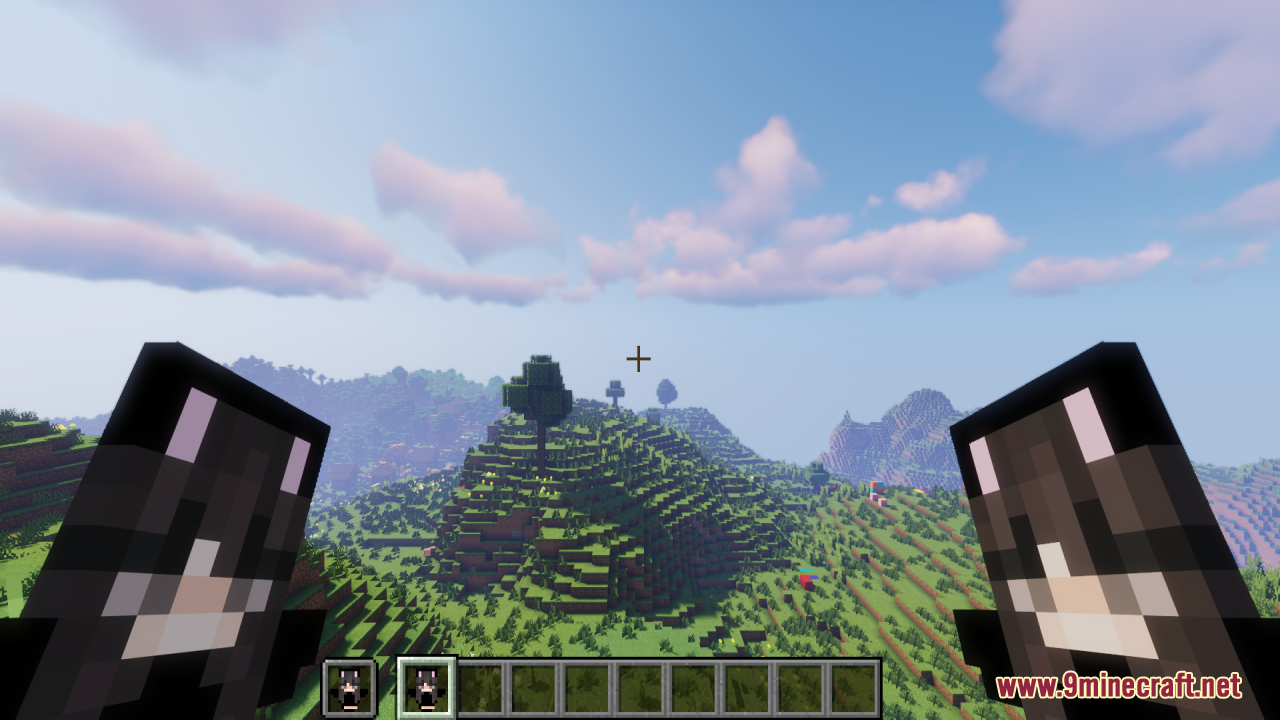 Player holding two custom totems while looking at a scenic mountain landscape