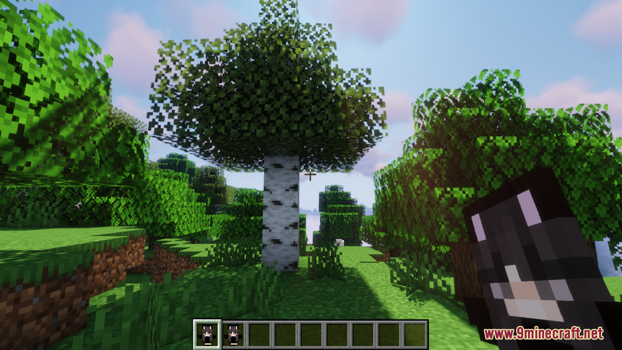 Player holding a custom totem item while looking at a birch tree outdoors