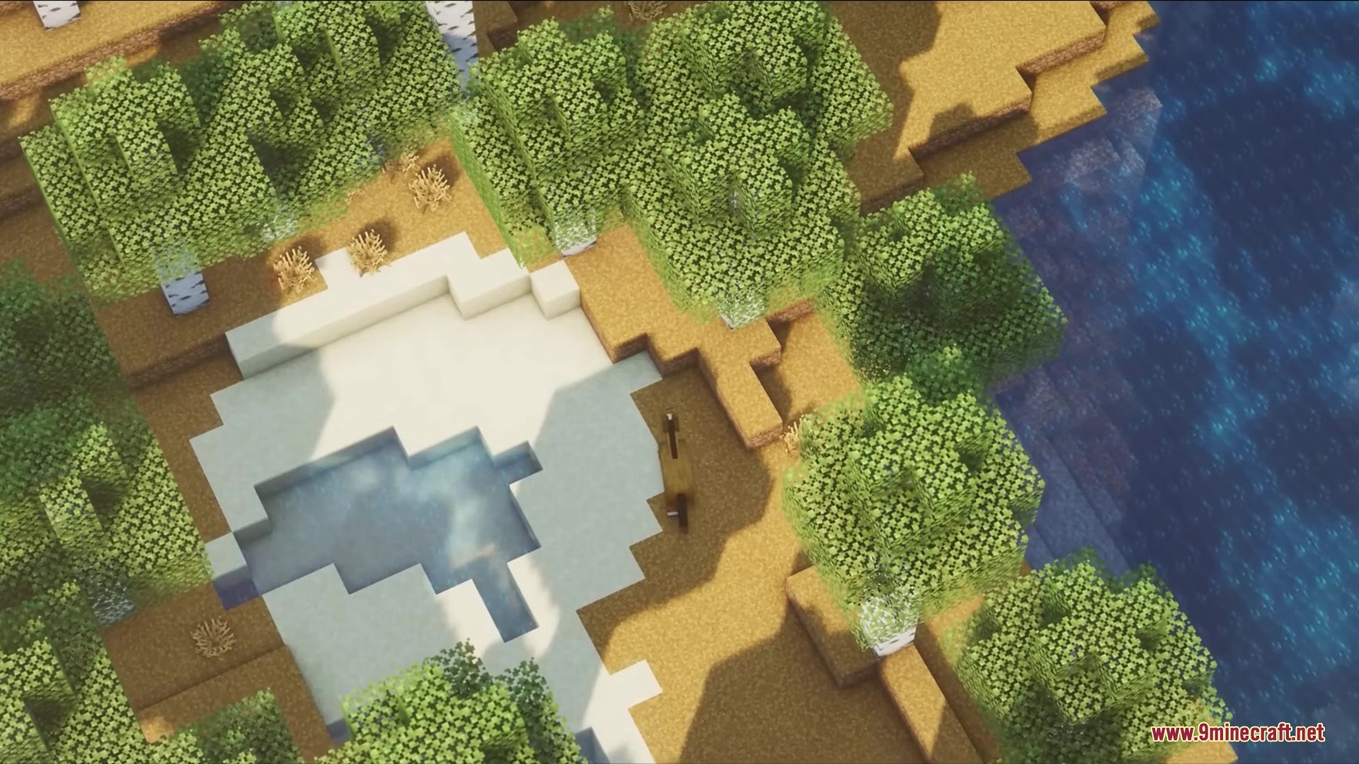 Blak Suit's Bushy Grass Resource Pack Screenshot 2 Aerial view of a Minecraft landscape with dense foliage and clear blue water