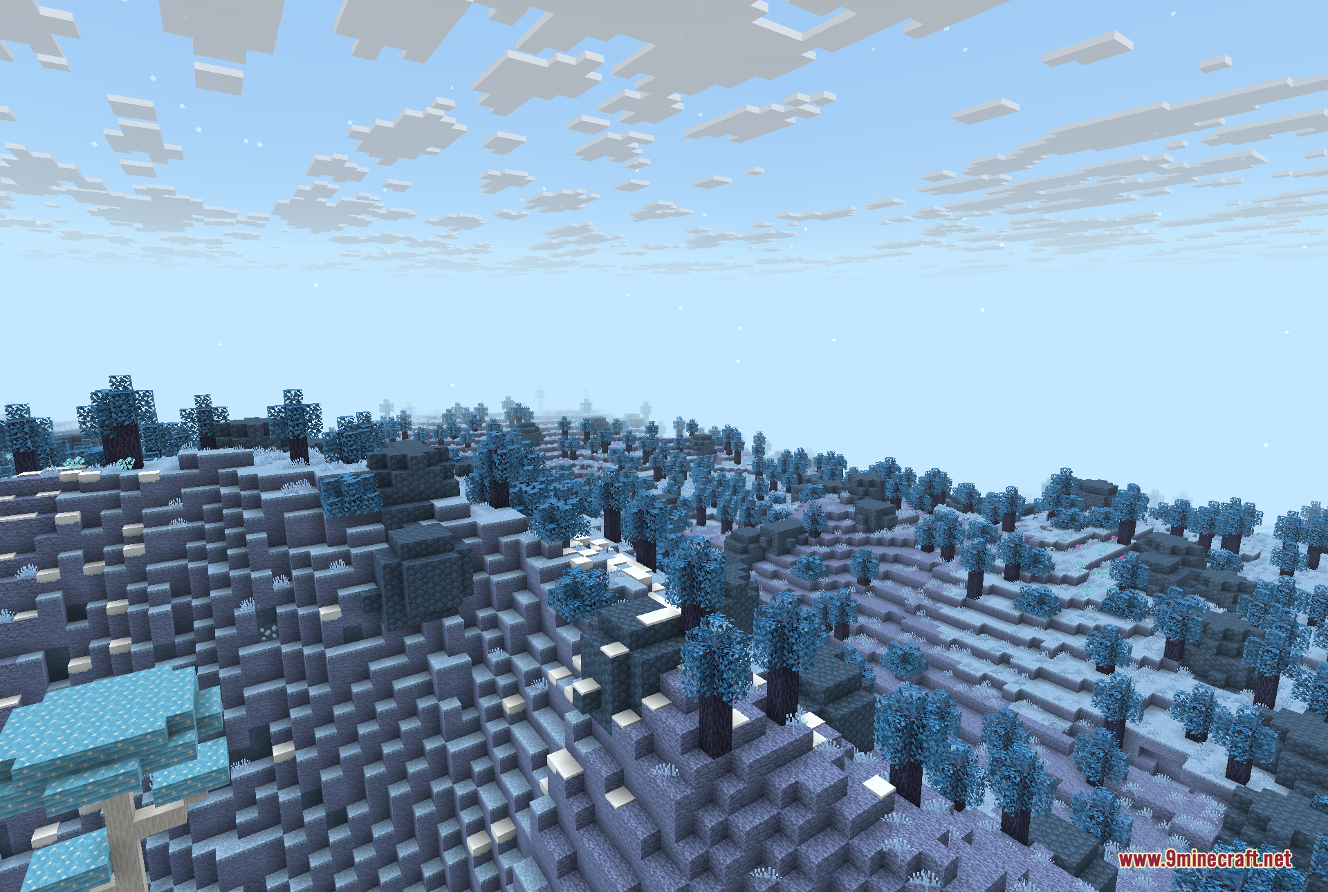 A view across the Everbright, the bright, snowy and cold dimension, with its pale blue-leaved trees, frost-covered stone terrain and turquoise crystal blocks under a clear blue sky.