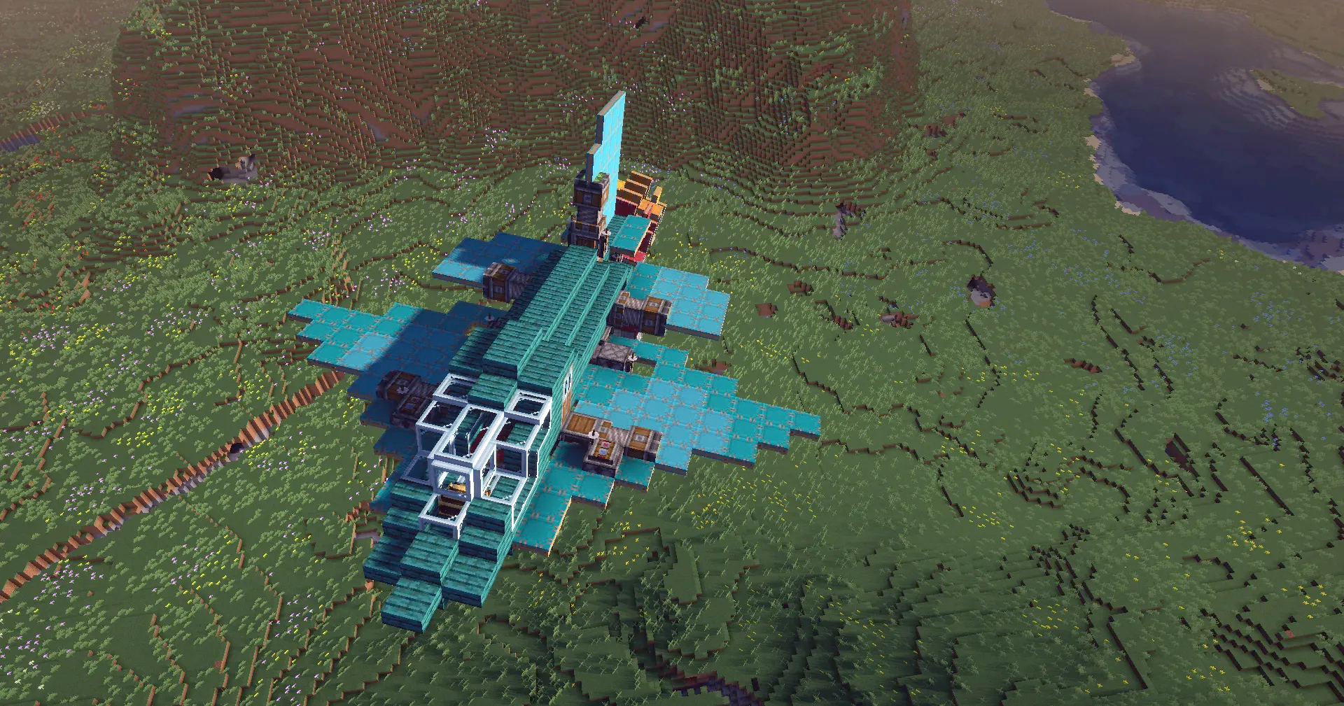 Top down view of a teal bomber plane flying over green Minecraft terrain