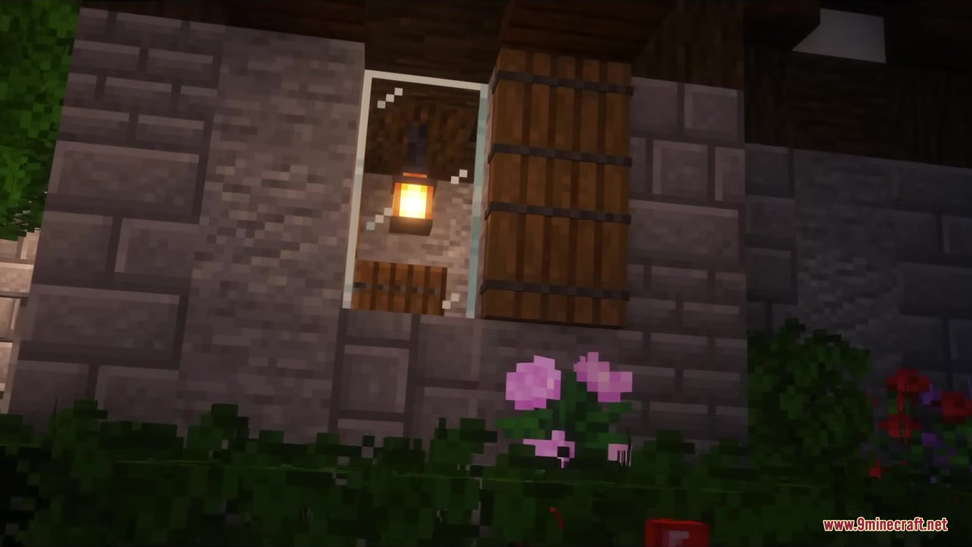 Bray's World a Vanilla Experience Resource Pack Screenshot 2 A stone house wall with pink flowers and a window showing a lantern
