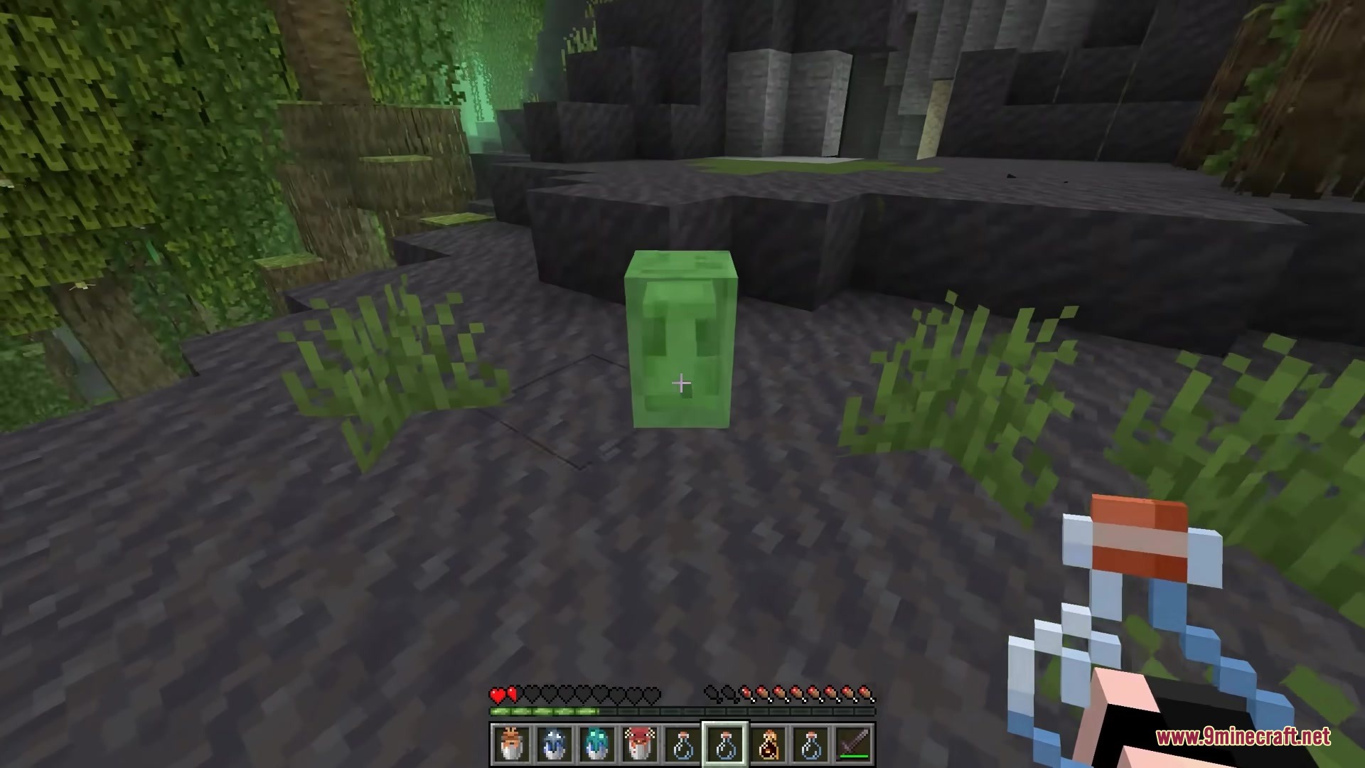 Bucketem Remodeled Resource Pack Screenshot 1 A player approaches a small green slime with an empty glass bottle