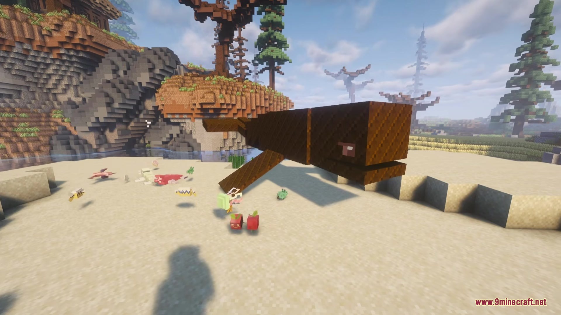 Candyverse Mod Screenshot 5 A giant chocolate whale mob rests on the beach near small candy items