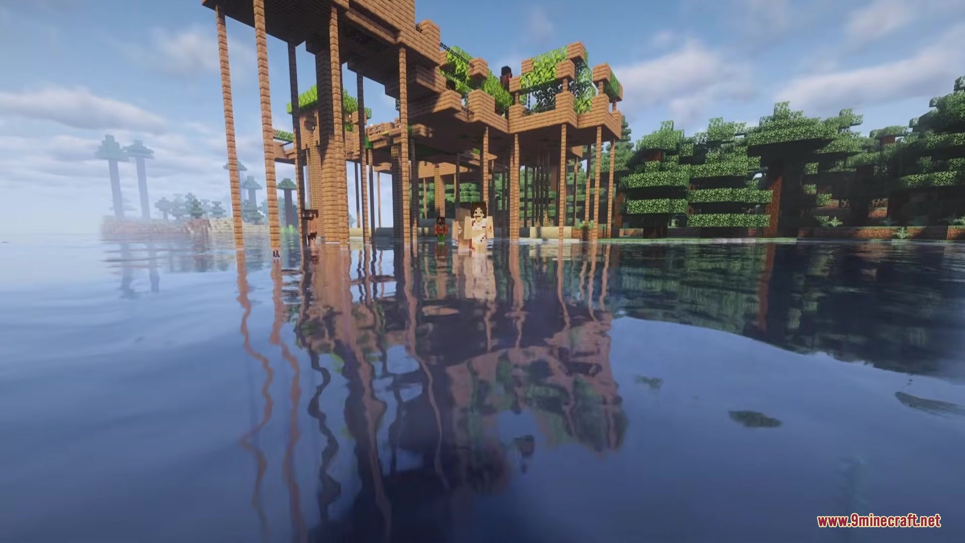 Cannibal Villages Mod Screenshot 2 Cannibals standing in the water near a wooden village built on tall stilts