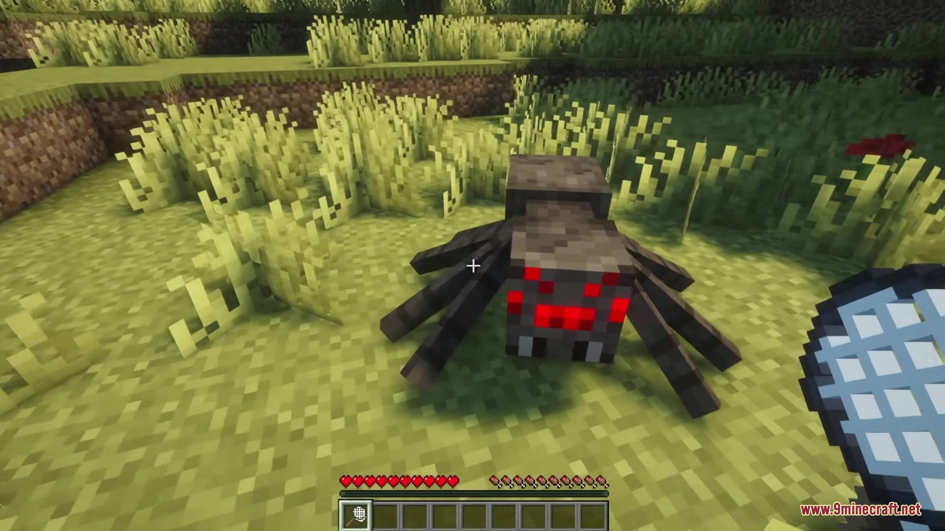 Capture Nets Mod Screenshot 4 Player aiming a capture net at a spider on the grass