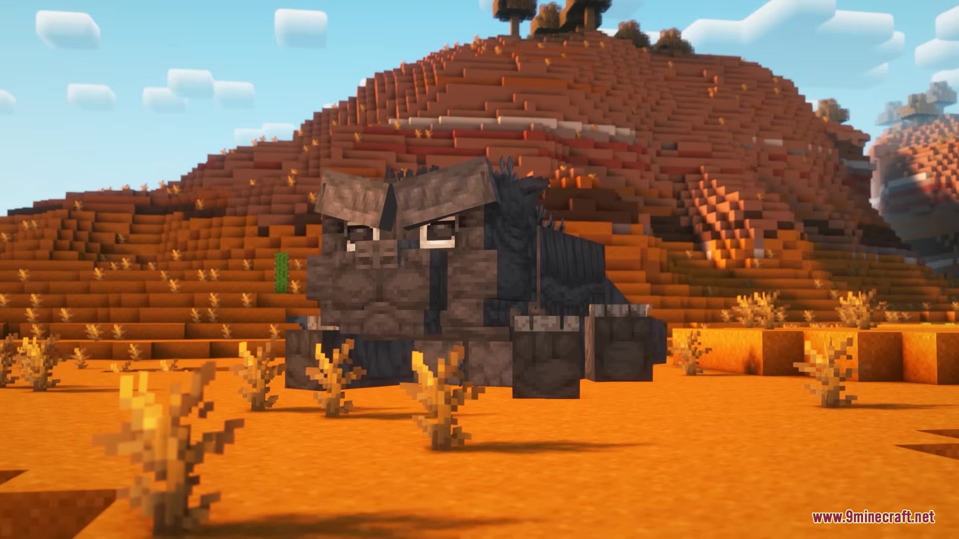 Catzilla Mod Screenshot 10 A giant grey cat monster sits near a mountain in the mesa biome