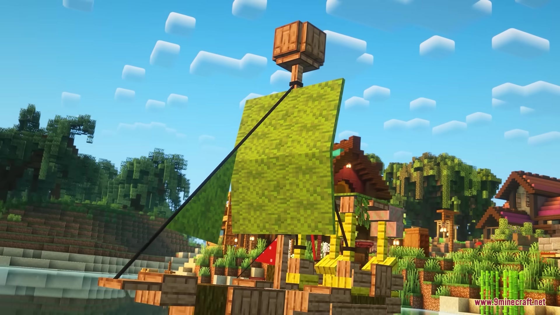 A wooden ship with green sails sits near a village in the jungle