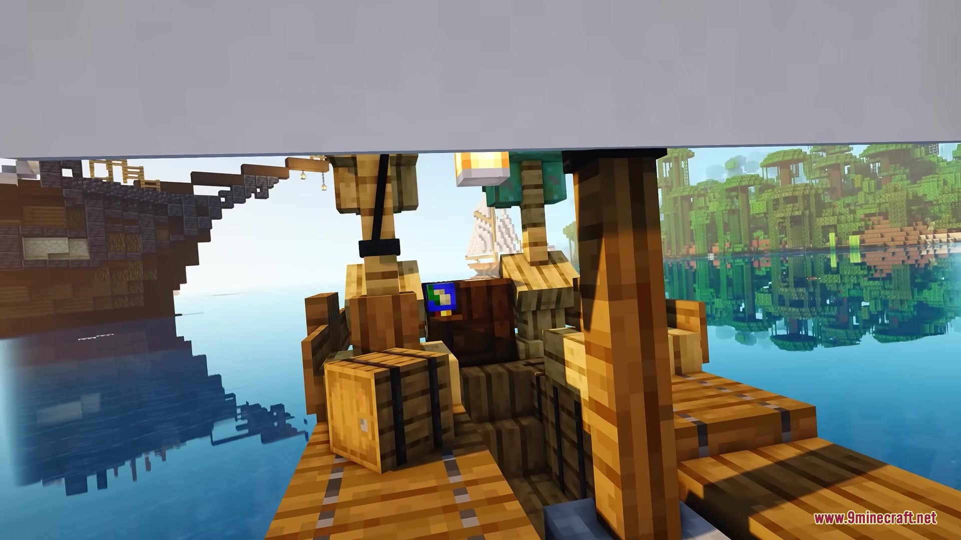 The deck of a wooden ship with barrels and a map overlooking water