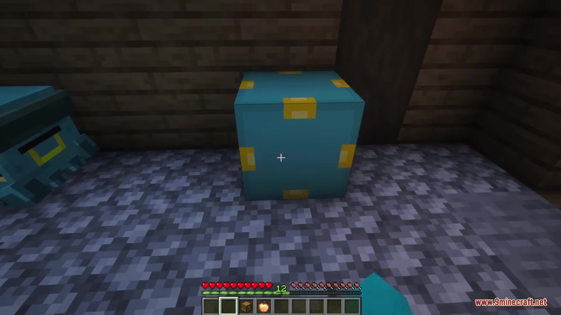 Chestmonster Mod Screenshot 1 A blue Chestmonster block placed on a stone floor inside a wooden building
