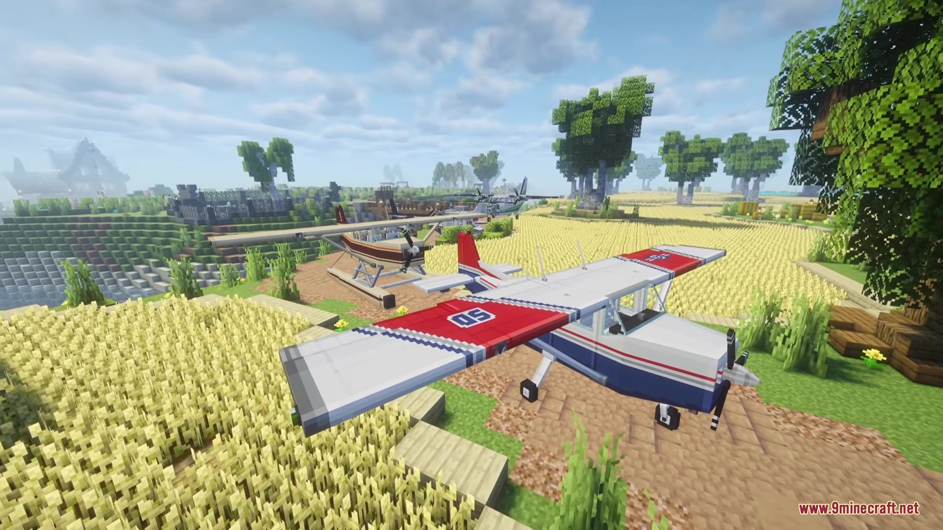 A white and blue plane parked in a large golden wheat field