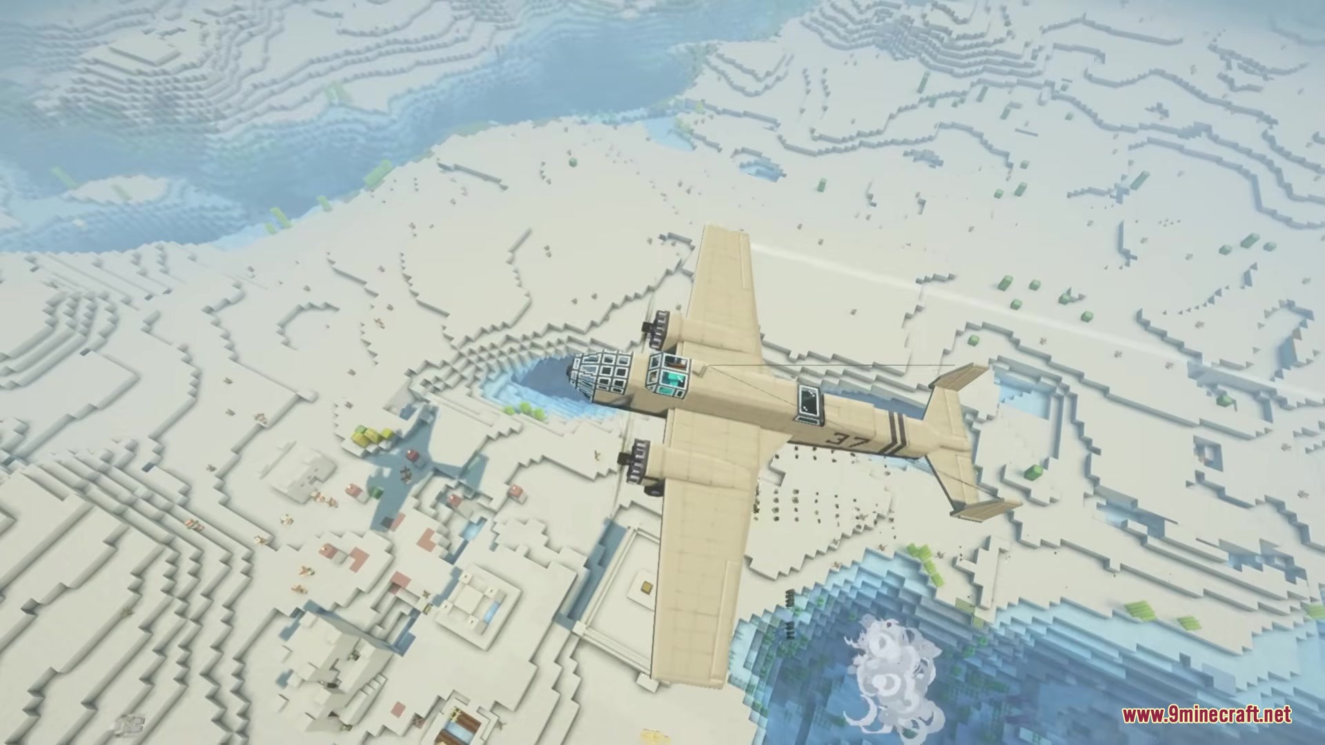 A tan twin engine aircraft soars above a vast desert landscape