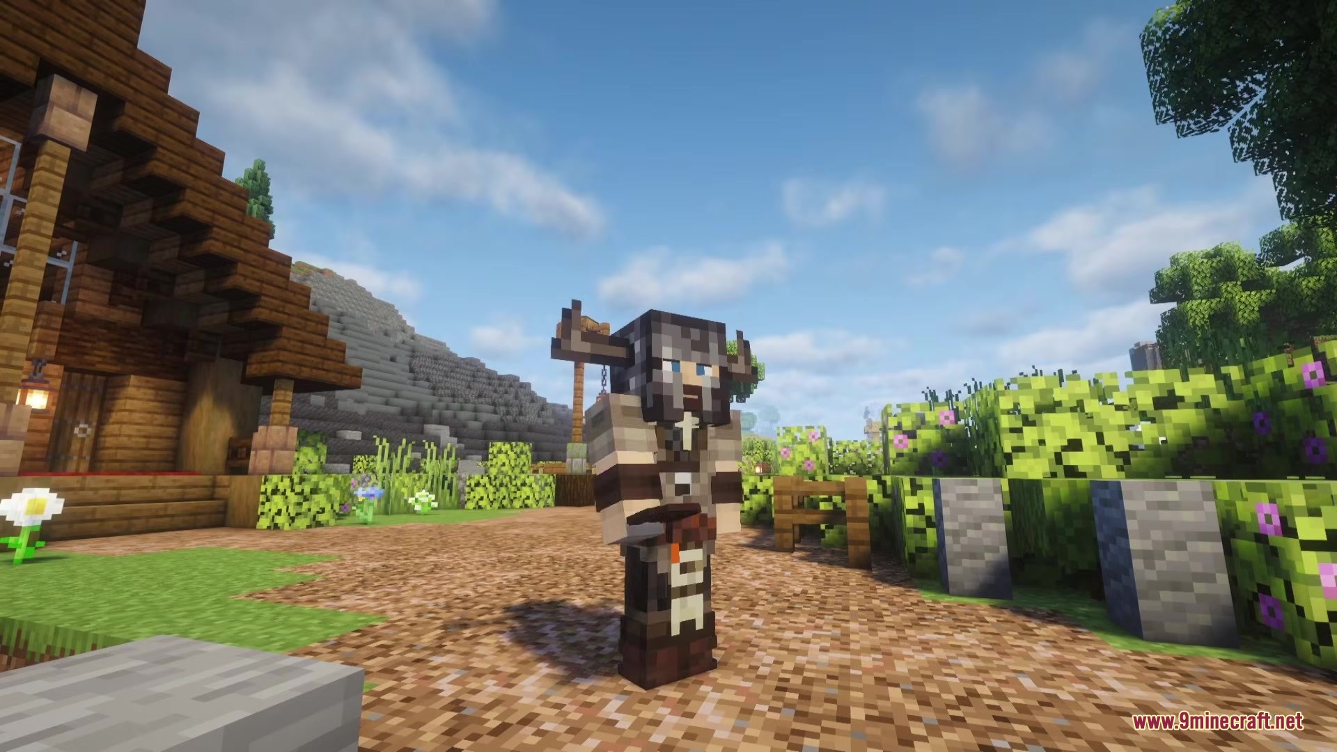 Clothing of the Lowlands Mod Screenshot 5 A character wearing dark horned armor stands on a dirt village path