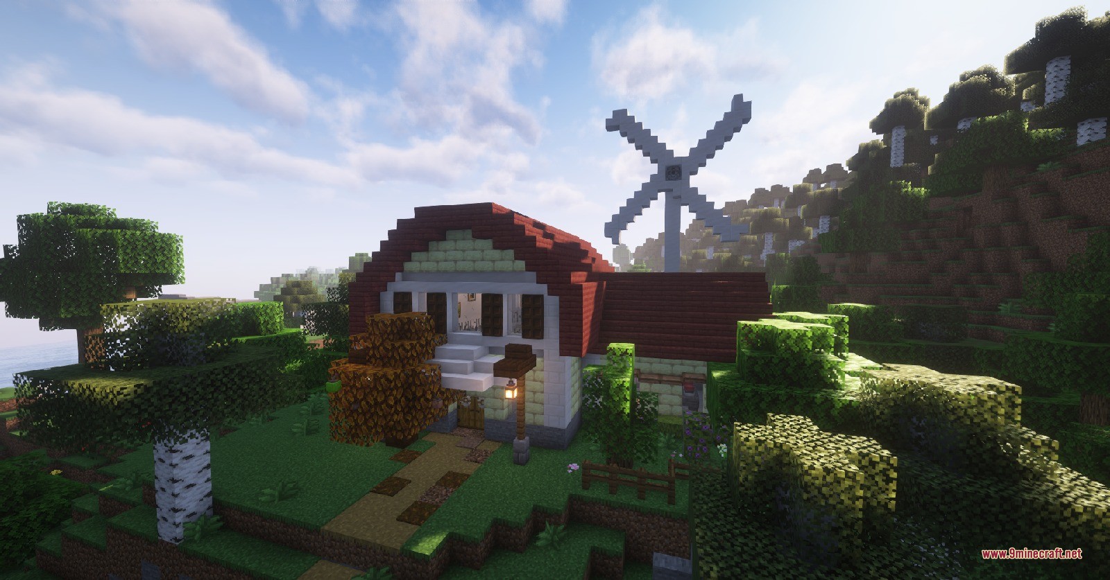 Minecraft house with red roof and windmill in a forest biome
