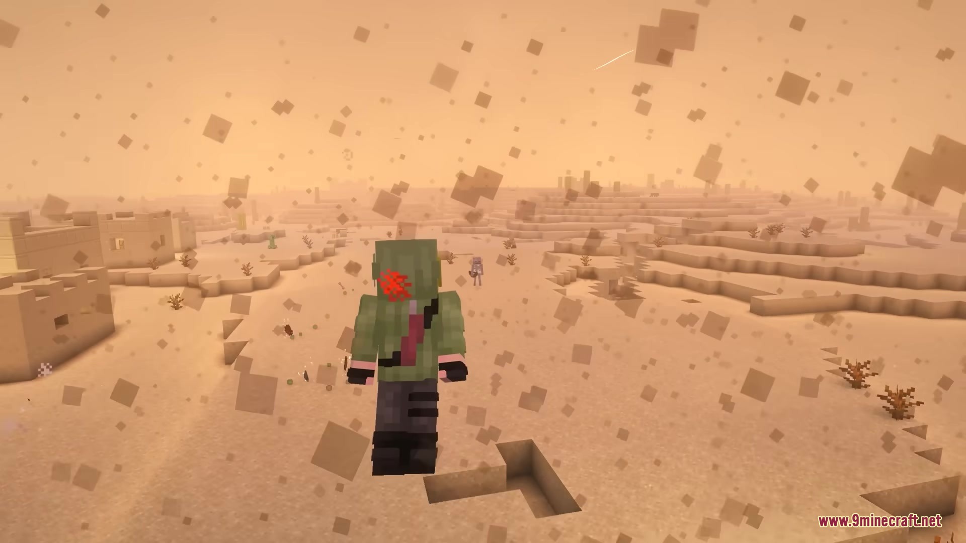 A player with red markings standing in a desert village during a sandstorm