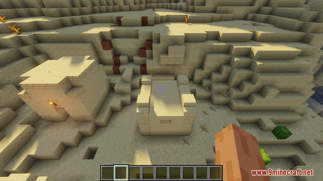 A small sand structure in a desert with a Creeper face crosshair