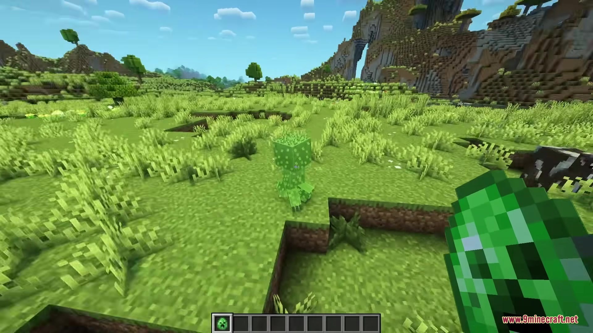 The player holds a spawn egg while looking at a fluffy movie creeper