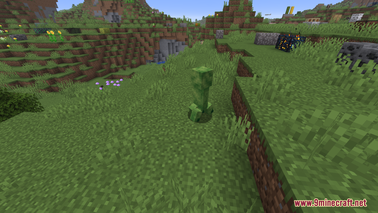 Creepers Refreshed Resource Pack Screenshot 5 A green Creeper stands on a grassy hill near a mob spawner