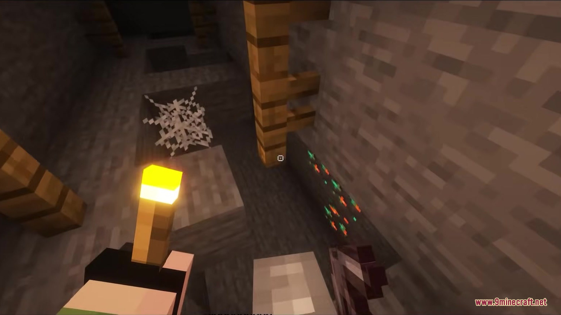 Crosshair CUBE Resource Pack Screenshot 7 Player holding a torch in a dark mineshaft with a square crosshair