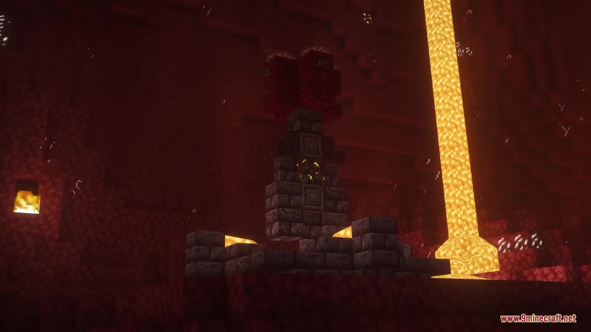 A mysterious stone structure standing near a flowing lava pillar in the nether