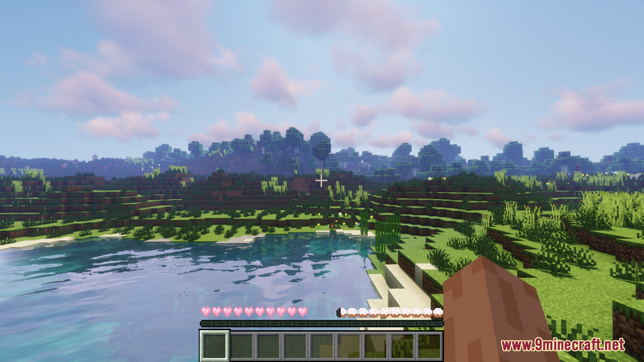 Pink heart health icons and white hunger bars displayed over a scenic Minecraft lake