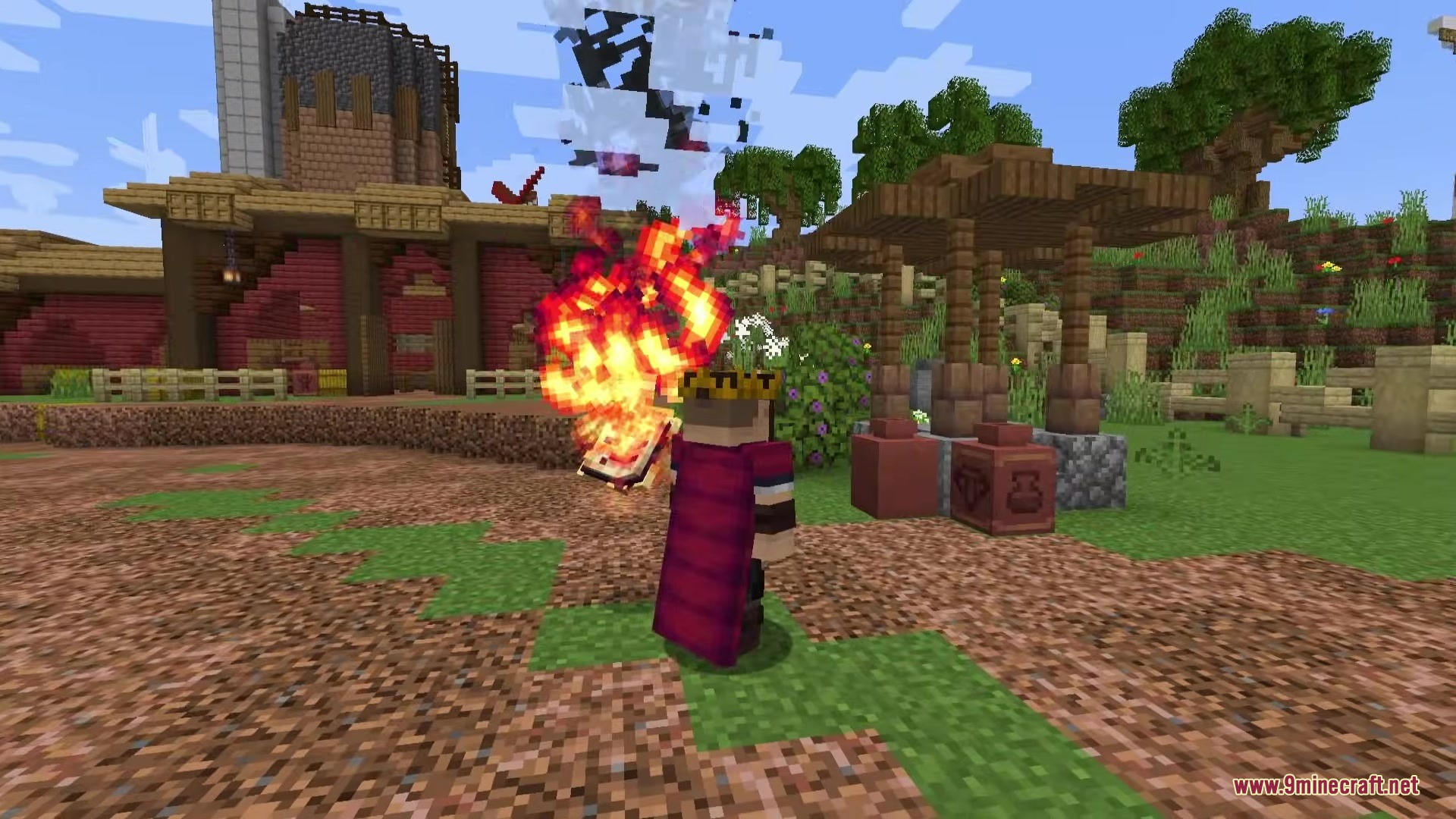 Danny's AOT Mod Screenshot 1 Player wearing a crown and cape holds a flaming book near a village