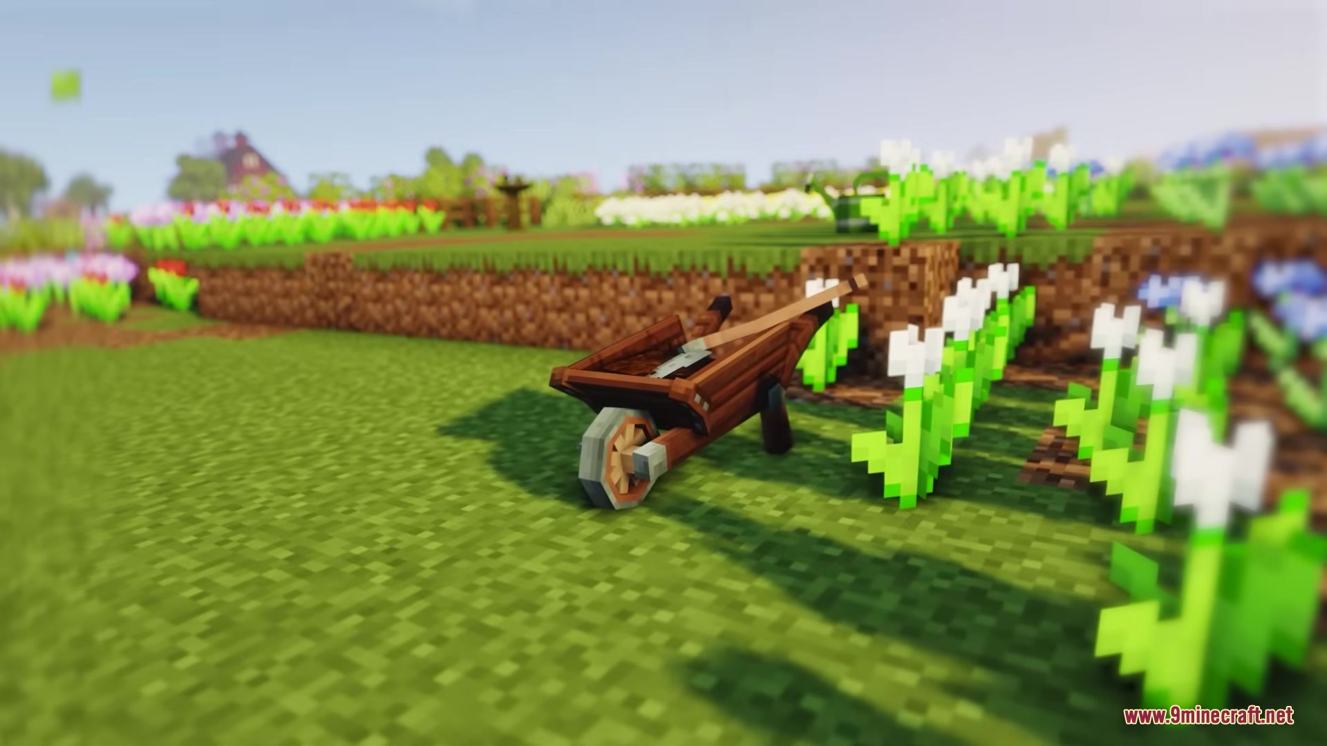 A wooden wheelbarrow with a shovel parked next to a row of flowers