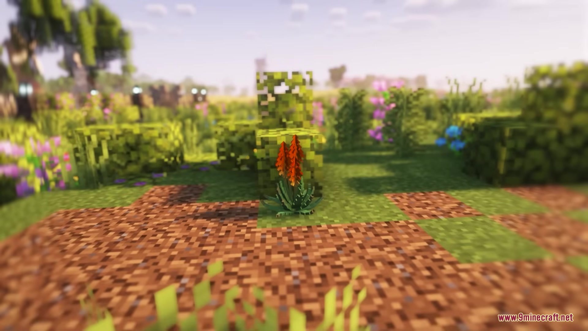 A red flowering plant from Deconature Mod stands in a grassy field