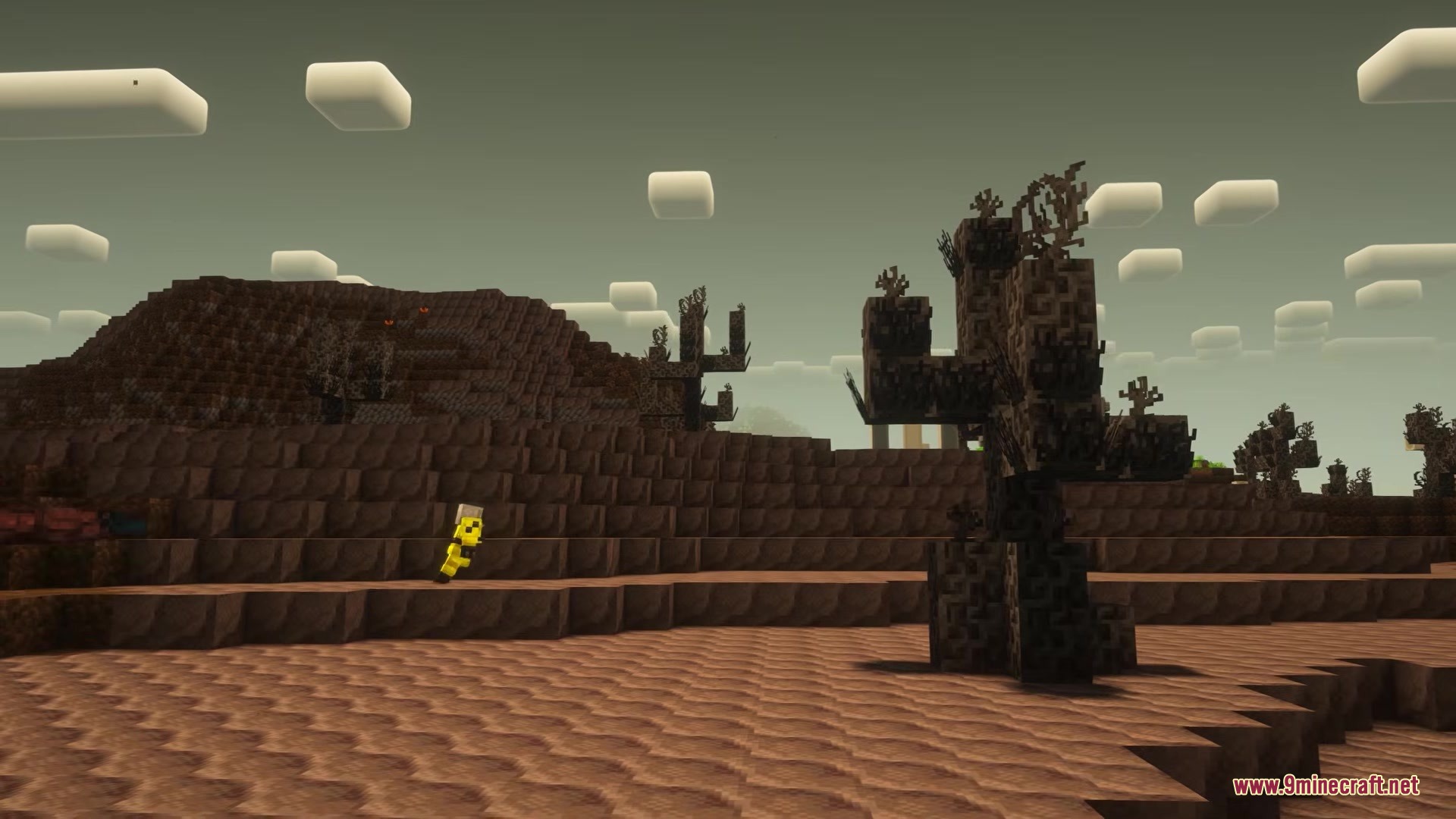 A yellow figure explores the Dehydrated Windlands filled with dark twisted trees