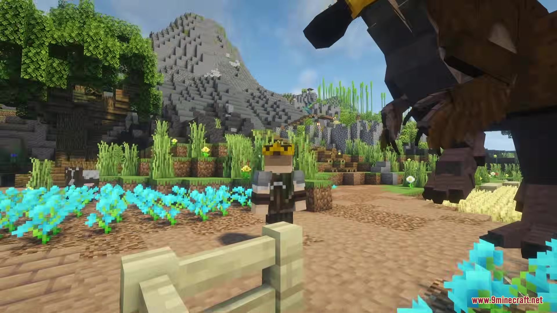 Dodo Rex Mod Screenshot 7 A player stands in a blue flower field next to a giant creature