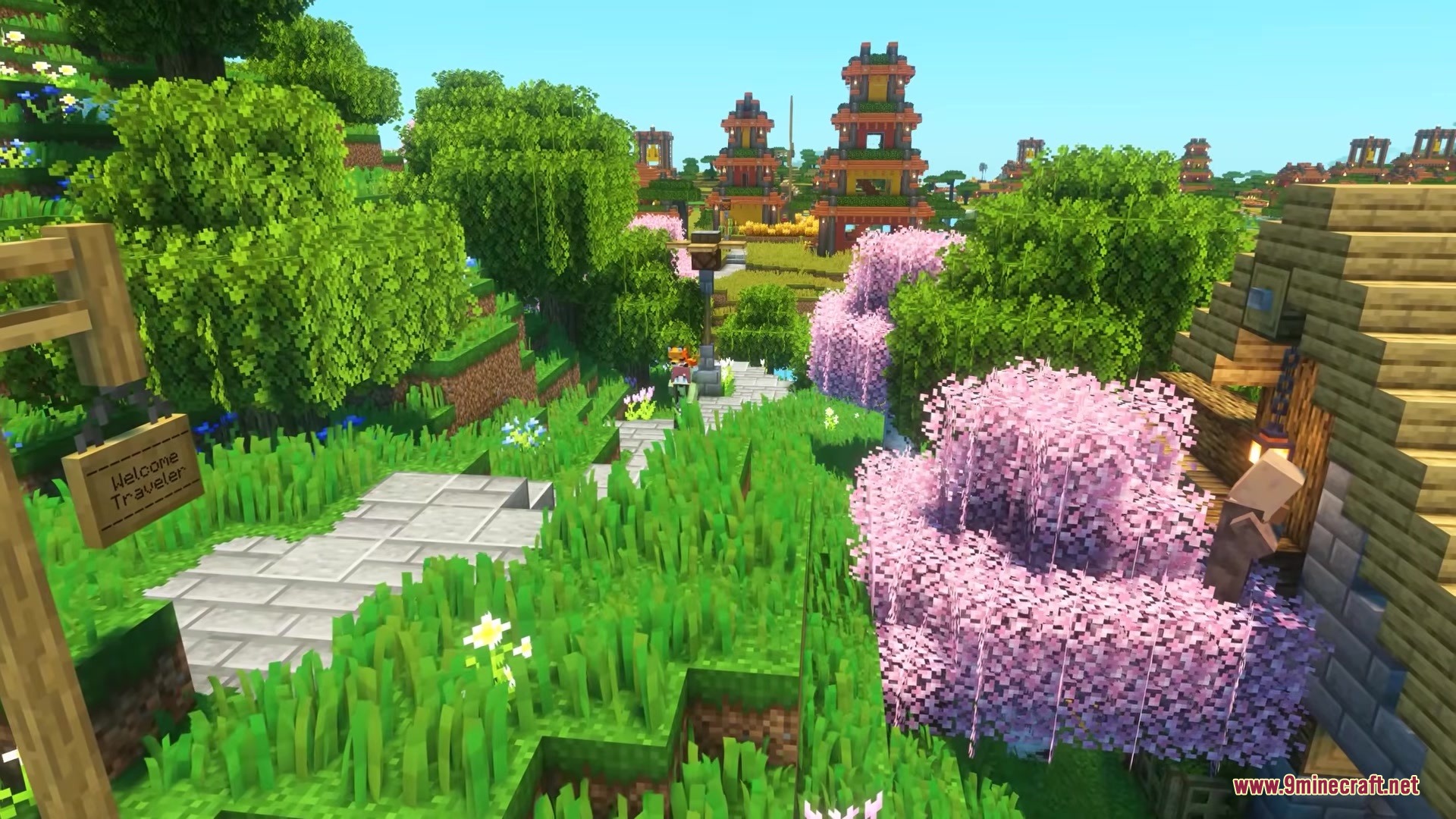 A stone path winds through a lush forest with pink cherry blossoms
