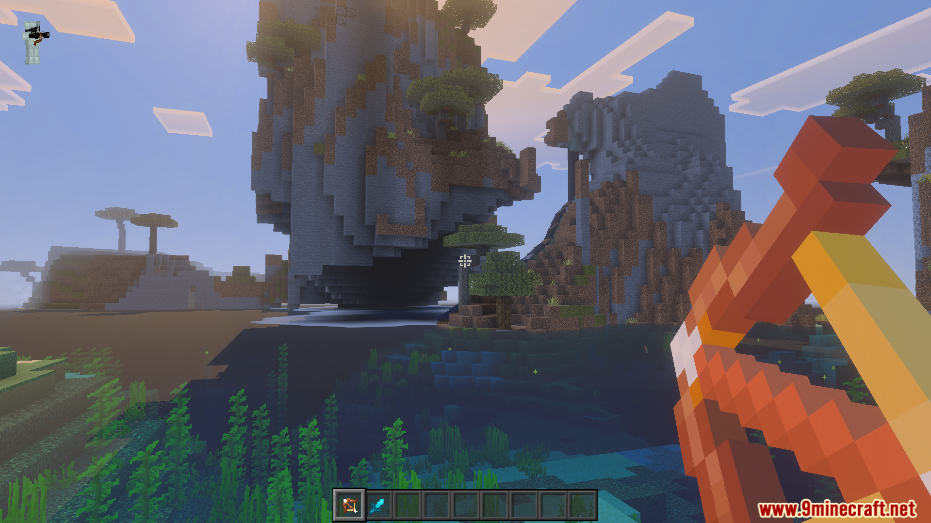 First person view holding a bow looking at large mountains and water