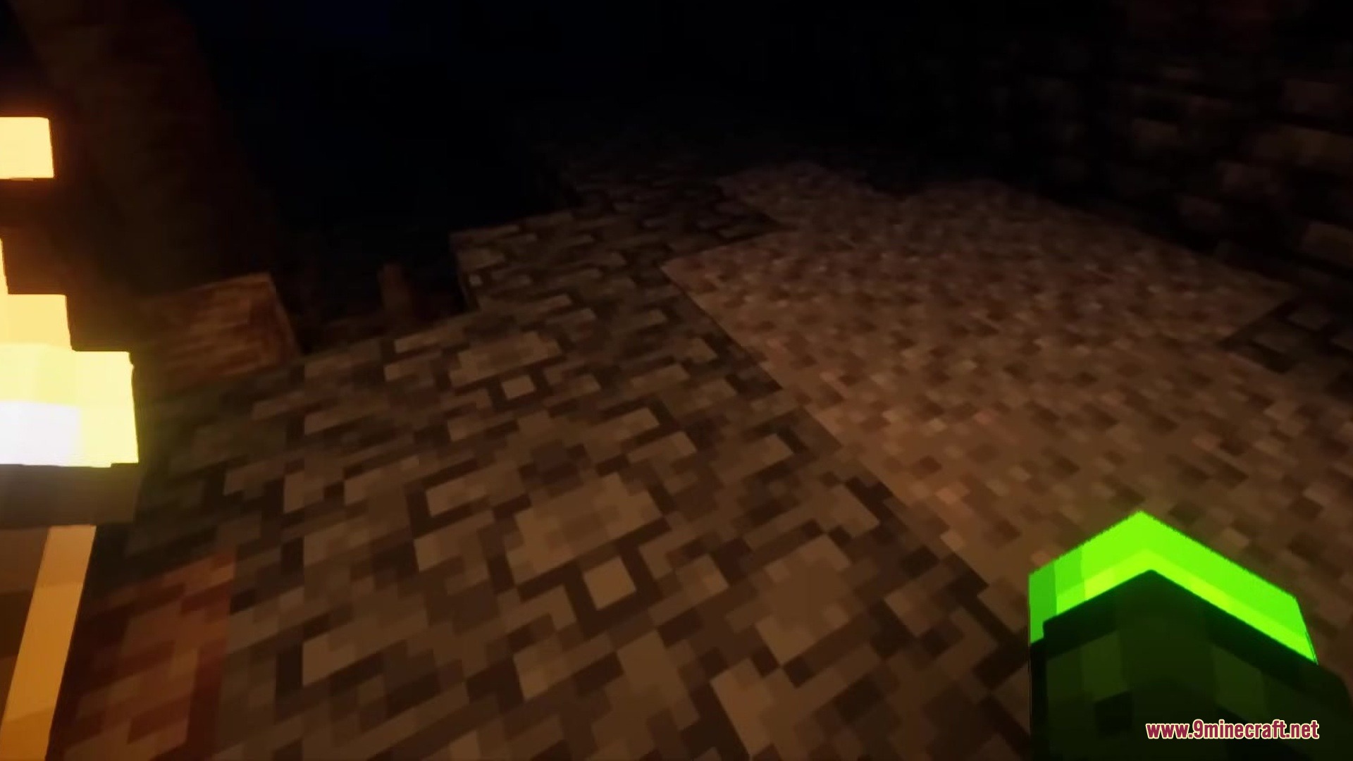 Enhanced Audio Ambience Sound Pack Resource Pack Screenshot 7 A player with a green arm explores a dark cave with a torch