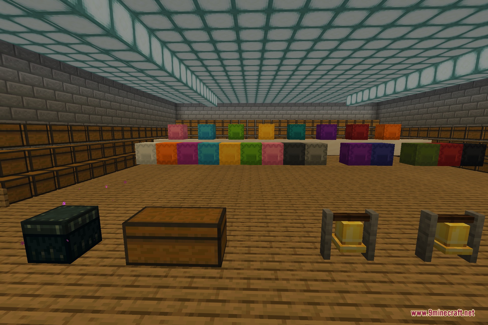 An ender chest, a wooden chest, and a pair of bells set out on the floor, with rows of coloured shulker boxes and barrels arranged behind them