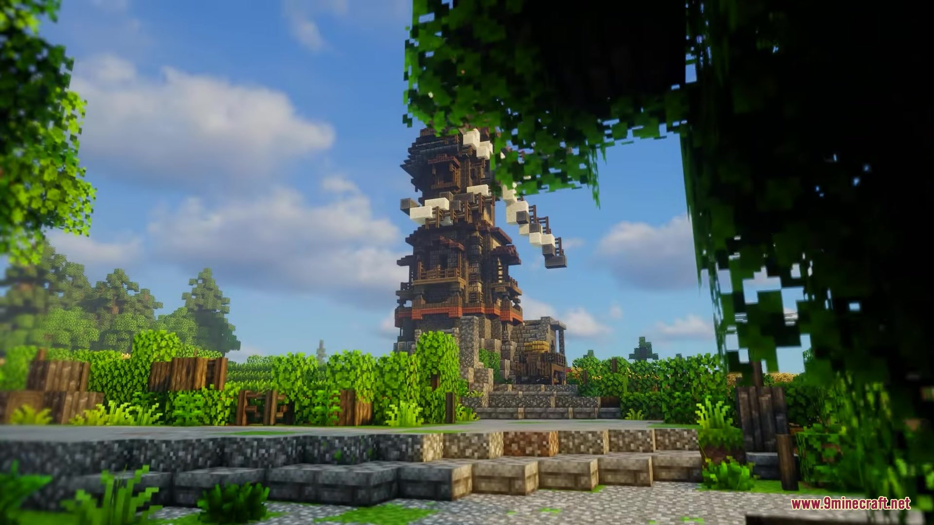Excalibur Fresh Animations Patch Resource Pack Screenshot 12 A tall medieval windmill stands among lush green trees and stone paths