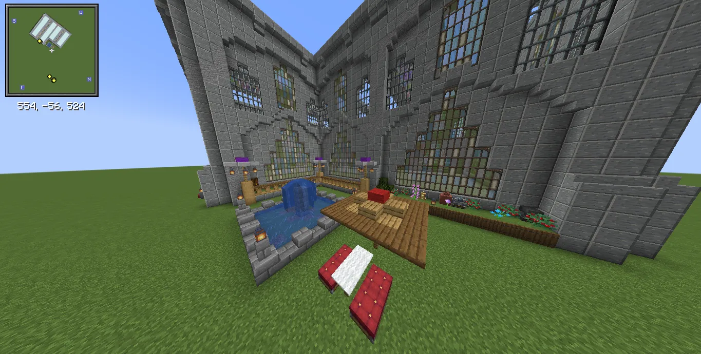 Factory Adg Schematic Screenshots 1 Outdoor courtyard area with a blue fountain and wooden picnic table set