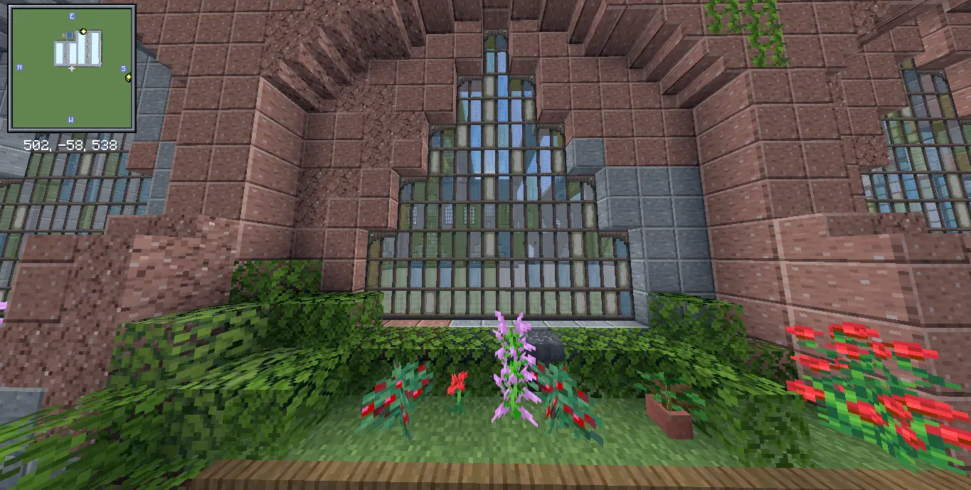 Factory Adg Schematic Screenshots 3 Lush green hedges and flowers decorating the base of a brick factory wall