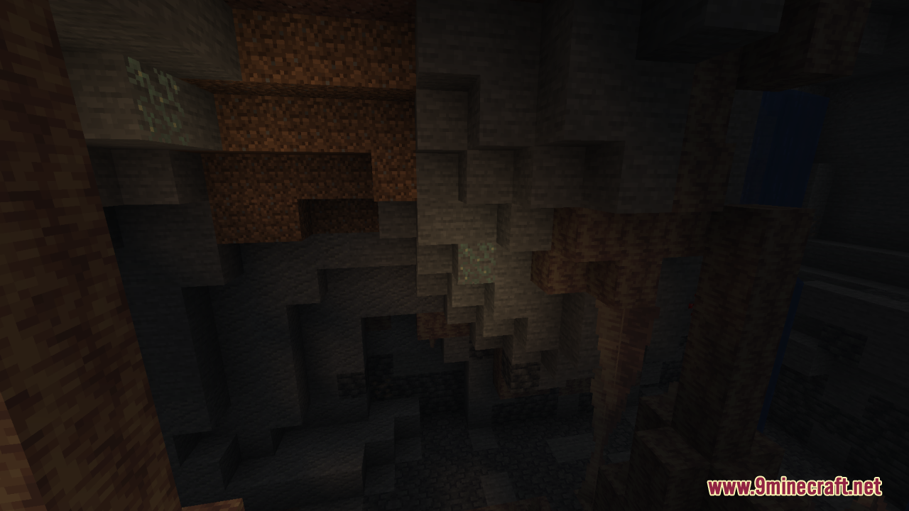 Jagged rock formations and deep shadows inside a dim Minecraft cavern