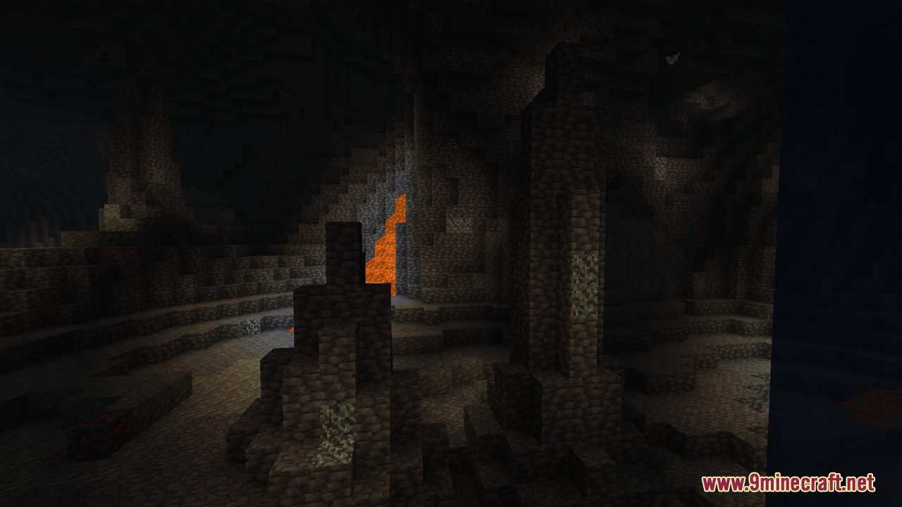 Dark underground cave in Minecraft with stone formations and distant lava