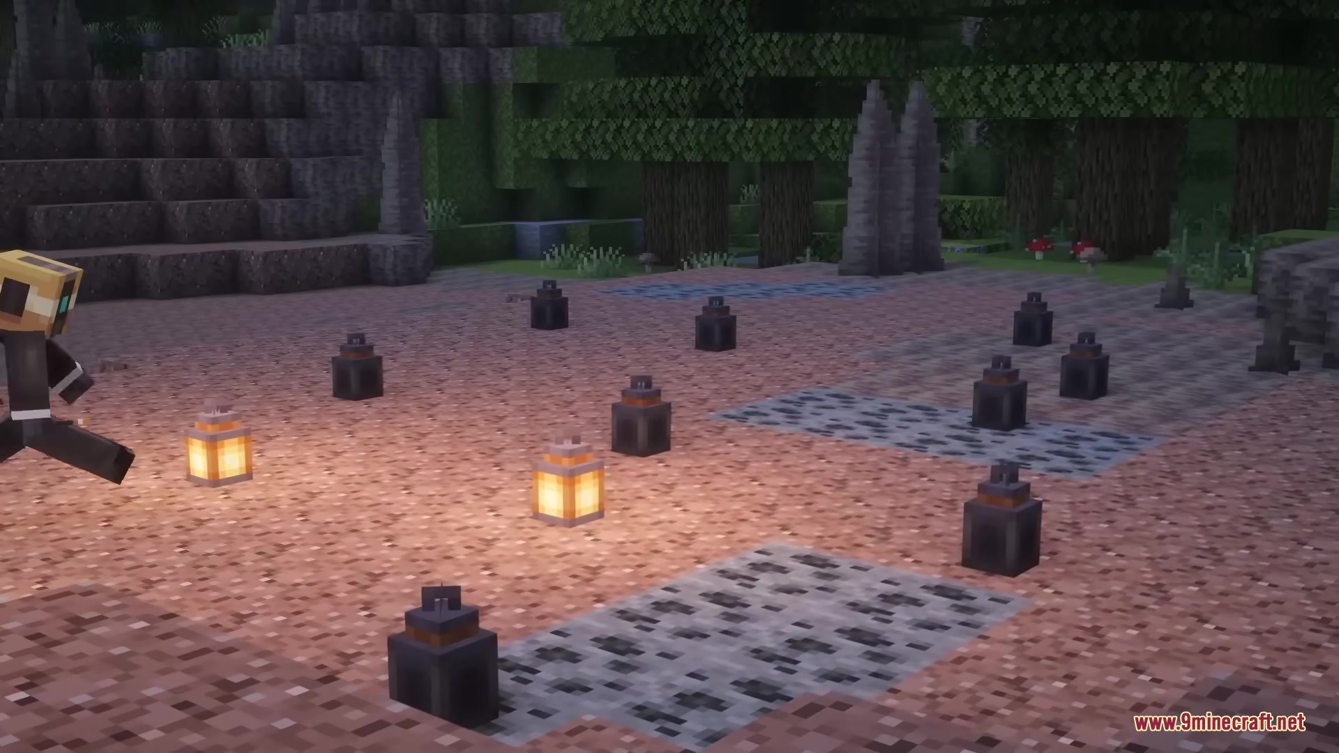 A player running past lit lanterns and burnt out torch remnants on ground