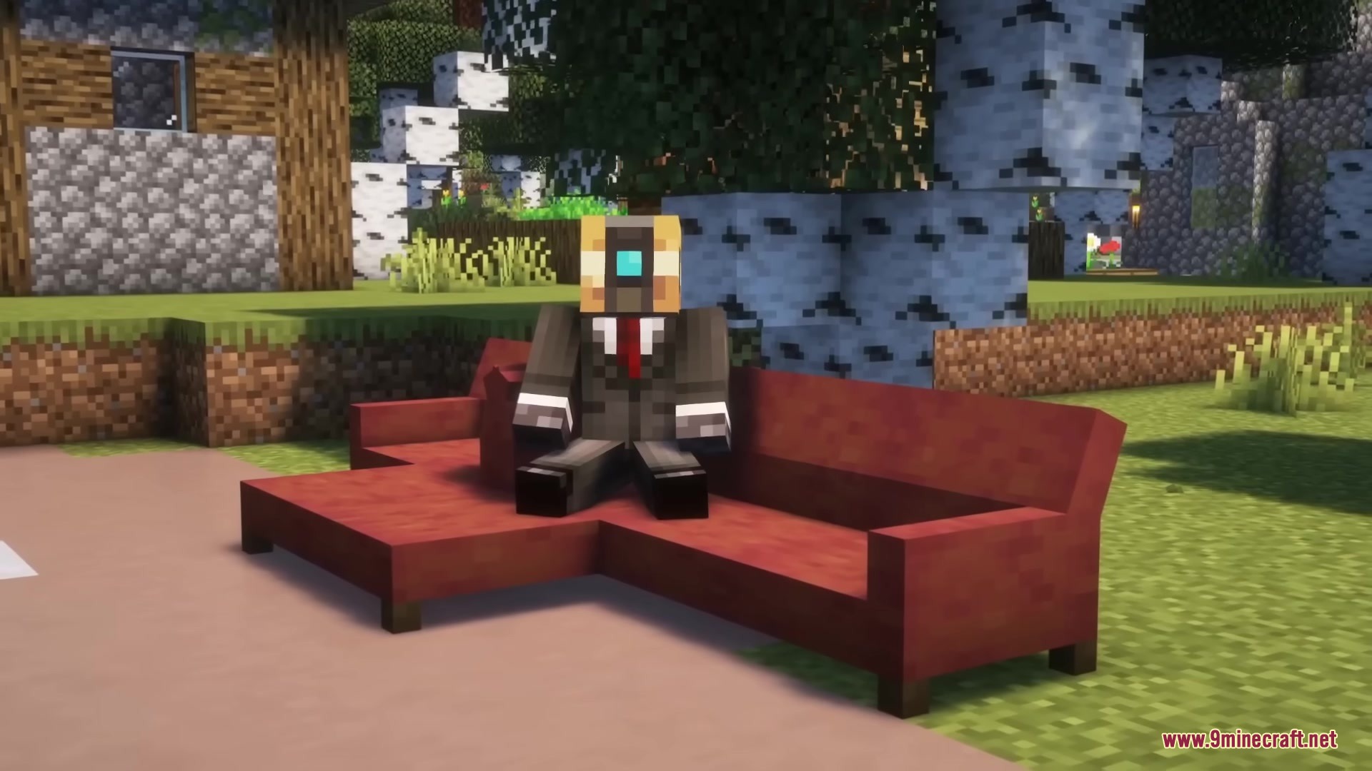 A Minecraft character in a suit sits on a red corner sofa