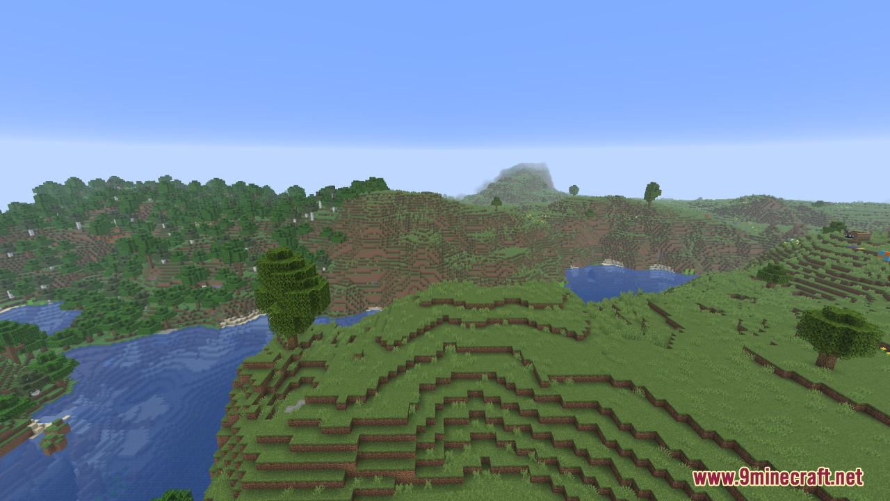 A scenic view of a river flowing between lush green hills and trees